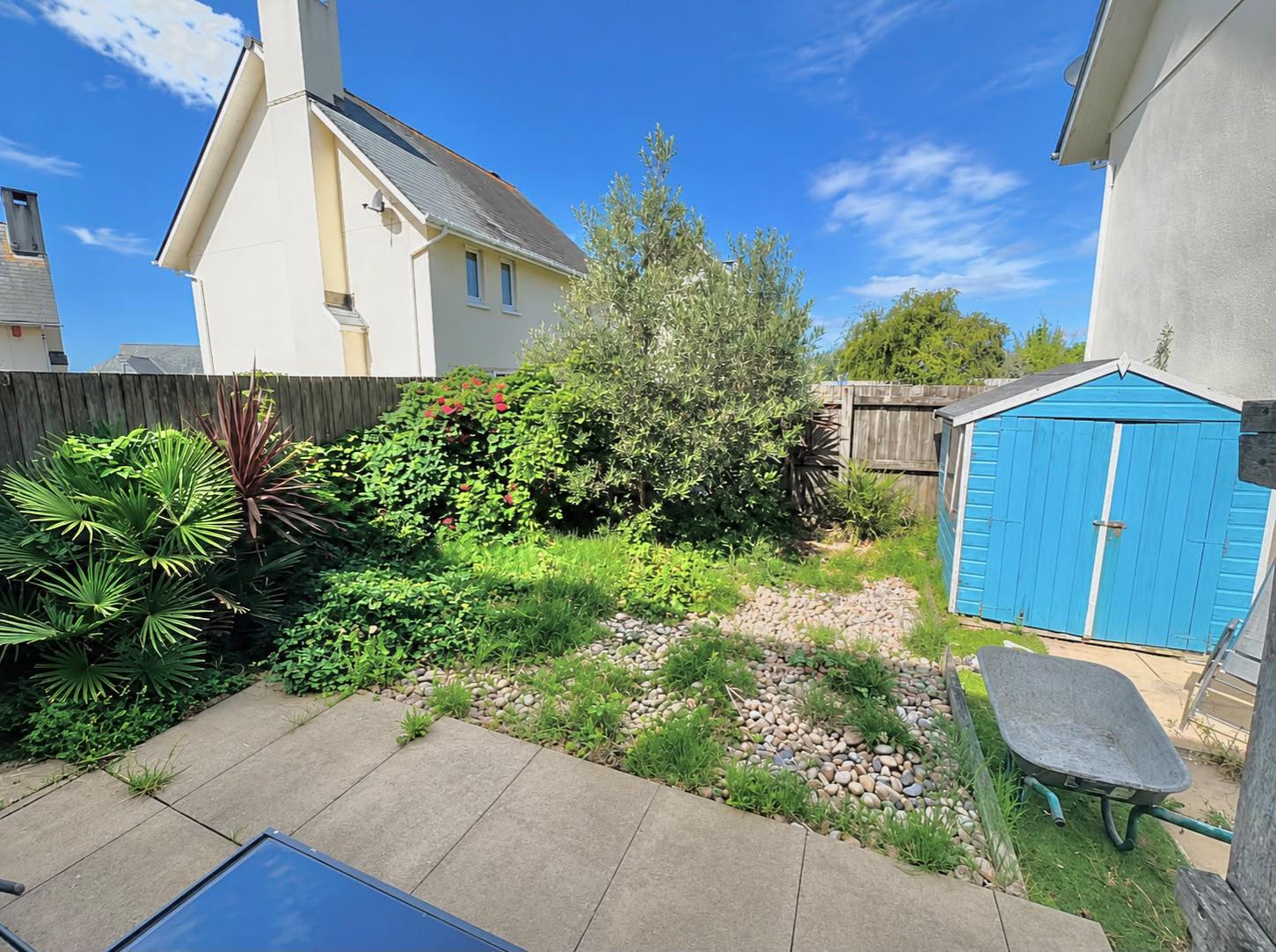 Before: overgrown garden cleared and turfed