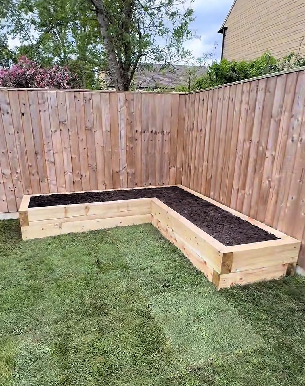 Sleeper raised bed with new fencing and turf